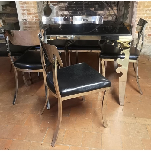 669 - A POLISHED CHROME DINING SUITE
Comprising a black glass top table and six black faux leather upholst... 