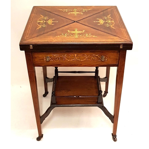 677 - AN EDWARDIAN ROSEWOOD AND MARQUETRY INLAID ENVELOPE CARD TABLE
The top decorated with urns and scrol... 