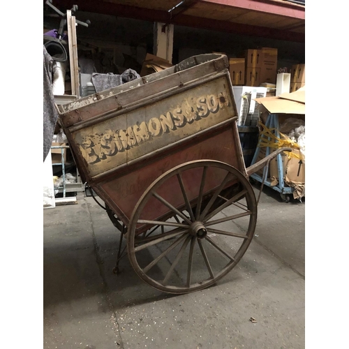 678 - A LATE VICTORIAN WOODEN TRADESMAN COVERED HAND CART
Branded E. Simmons and Son, iron bound spoke whe... 