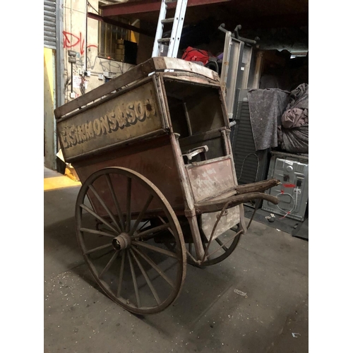 678 - A LATE VICTORIAN WOODEN TRADESMAN COVERED HAND CART
Branded E. Simmons and Son, iron bound spoke whe... 