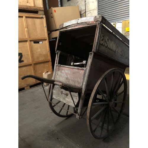 678 - A LATE VICTORIAN WOODEN TRADESMAN COVERED HAND CART
Branded E. Simmons and Son, iron bound spoke whe... 