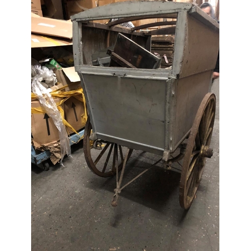 679 - AN EDWARDIAN WOODEN TRADESMANS COVERED HAND CART
Light grey painted finish, iron bound spoke wheels.... 