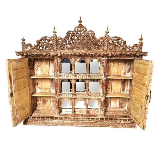 685 - A VENETIAN DESIGN WALL MOUNTED MIRRORED BACK CABINET
With pierced floral fretwork pediment above gal... 
