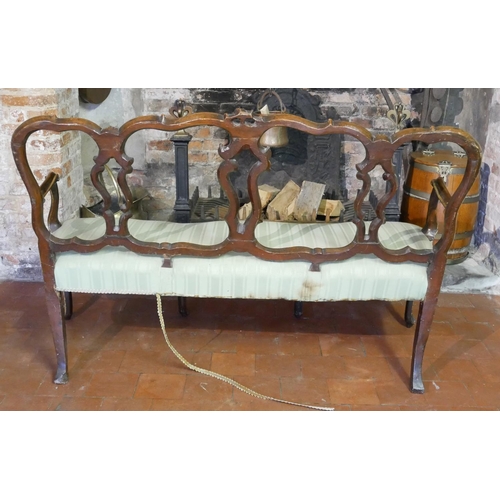 687 - AN 18TH CENTURY ITALIAN WALNUT AND PARCEL GILT OPEN ARM CHAIR SETTEE
With pierced strap work back an... 