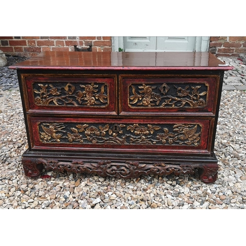 690a - A 19TH CENTURY CHINESE LOW CHEST OF TWO SHORT ABOVE ONE LONG DRAWER
With red lacquered and organic c... 