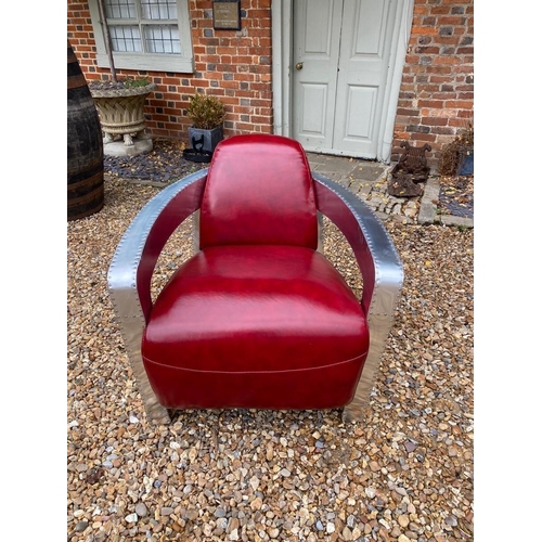 693 - A STYLISH RED LEATHER AND ALUMINIUM AVIATION ARMCHAIR.
(74cm x 80cm x 73cm)

Condition: good a few m... 