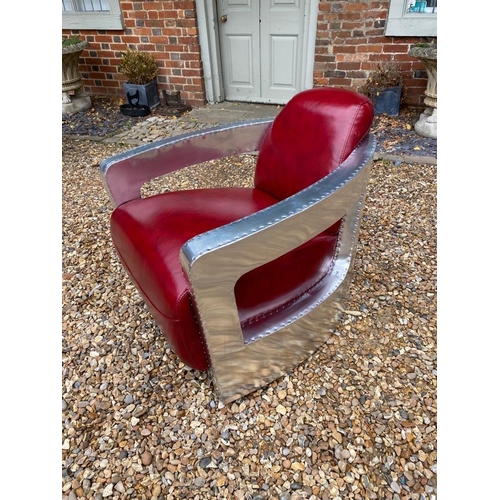 693 - A STYLISH RED LEATHER AND ALUMINIUM AVIATION ARMCHAIR.
(74cm x 80cm x 73cm)

Condition: good a few m... 