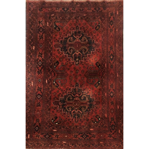 695 - KHAN MOHAMMADI, AN AFGHAN WOOLLEN RUG
With two geometric designs to central field with running borde... 