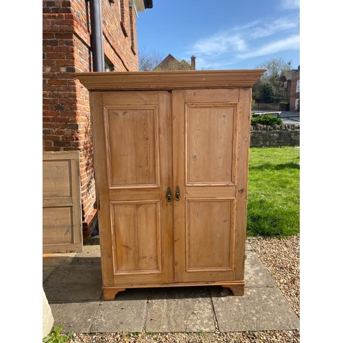697 - A VICTORIAN WAXED PINE DOUBLE WARDROBE
With two panelled doors.