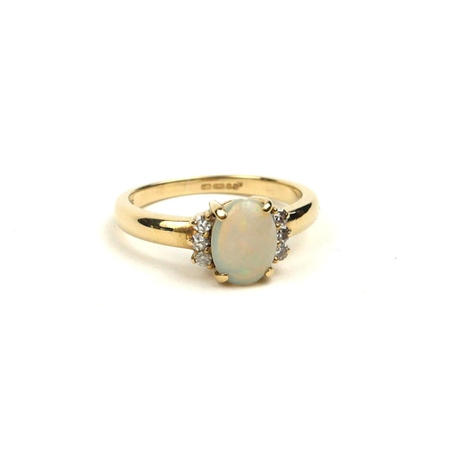 98a - A VINTAGE 9CT GOLD, OPAL AND DIAMOND RING
The oval cabochon cut opal edged with diamonds (size M).
(... 