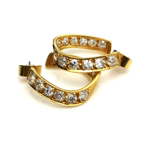 386 - A PAIR OF 18CT GOLD AND DIAMOND HOOP EARRINGS
The arrangement of round cut diamonds forming a horses... 