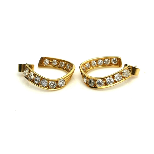 386 - A PAIR OF 18CT GOLD AND DIAMOND HOOP EARRINGS
The arrangement of round cut diamonds forming a horses... 