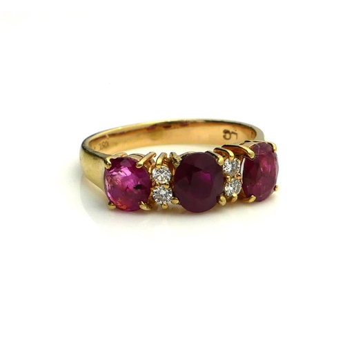 388 - AN 18CT GOLD, RUBY AND DIAMOND RING
Having a row of three oval cut rubies interspersed with round cu... 