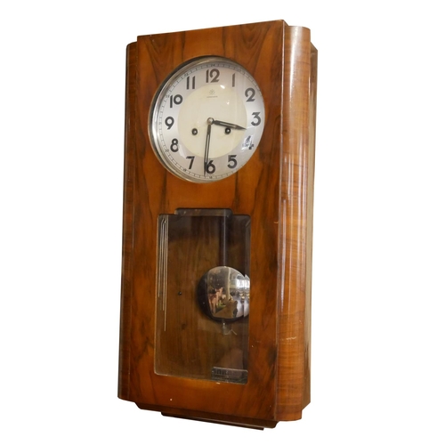 402 - AN EARLY 20TH CENTURY WALNUT AND CHROME WALL CLOCK
Having a silver tone dial marked Junghans and chi... 