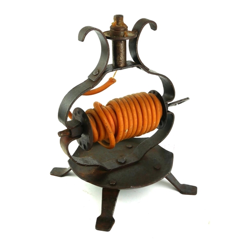 404 - A 20TH CENTURY WROUGHT IRON WAX JACK
Containing a wax coil candle and heart form handle. 
(approx 28... 