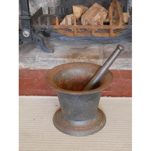 443 - A LARGE 19TH CENTURY CAST IRON PESTLE  AND MORTAR
Classical bell form, on a circular base. 
(approx ... 