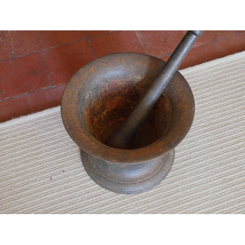 443 - A LARGE 19TH CENTURY CAST IRON PESTLE  AND MORTAR
Classical bell form, on a circular base. 
(approx ... 