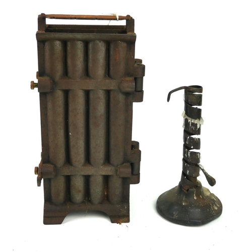 456 - AN 18TH CENTURY IRON RUSH LIGHT HOLDER ON WOODEN BASE 
Along with a cast iron eight section candle m... 