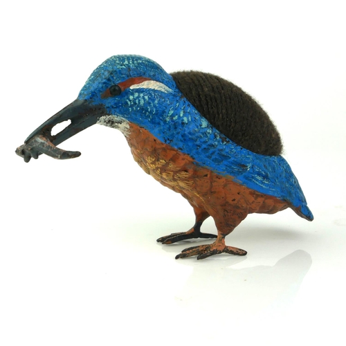 482 - A COLD PAINTED METAL KINGFISHER
With fish to beak and velvet cushion to back. 
(approx 14cm x 7cm)