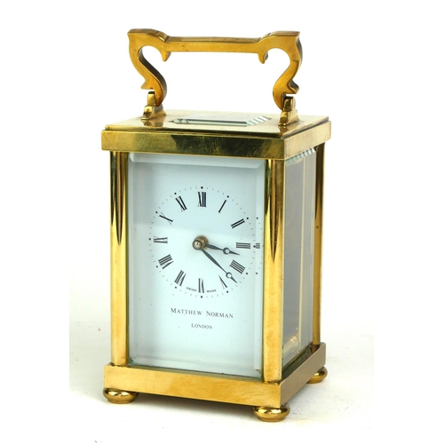 490 - MATHEW NORMAN, A 20TH CENTURY  GILT BRASS CARRIAGE CLOCK
Having a single carry handle, visual escape... 