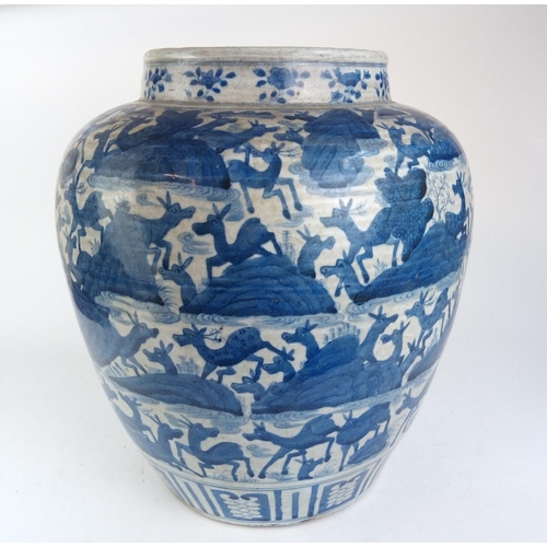 494 - A LARGE CHINESE BLUE AND WHITE OVOID POTTERY VASE
Decorated with multi deer with stylised rocks, bea... 