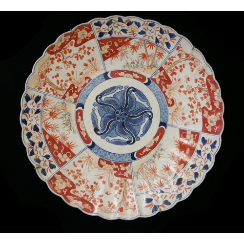 495 - A 19TH CENTURY JAPANESE IMARI PORCELAIN CHARGER PLATE
Chrysanthemum form with underglaze blue and ir... 