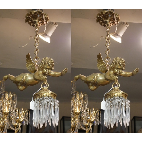 517 - A PAIR OF DECORATIVE GILT BRONZE HANGING CHERUB CHANDELIERS 
Each holding a single light with crysta... 