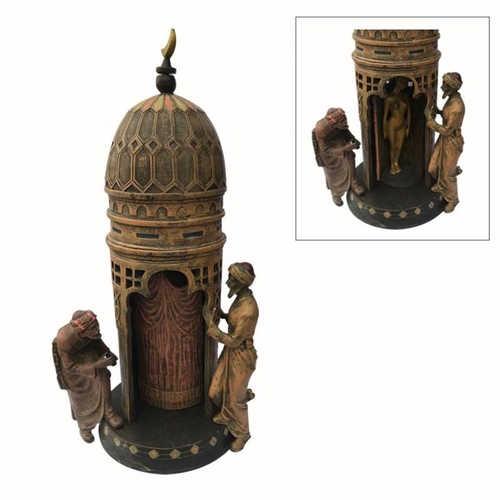 523 - A COLD PAINTED BRONZE FIGURAL EROTIC GROUP ORNAMENT
An Arabic tower with pierced gallery, two male o... 