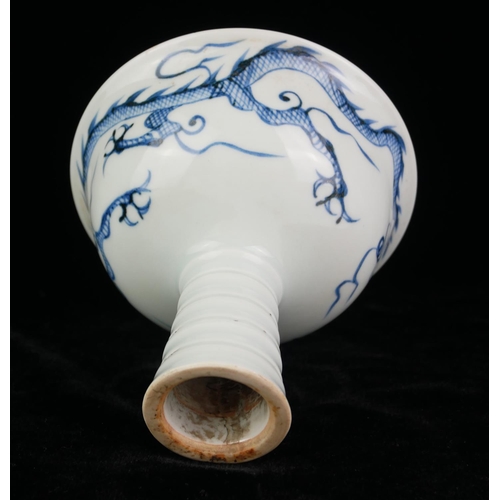 524 - A 20TH CENTURY CHINESE DESIGN BLUE AND WHITE PORCELAIN STEM CUP
Interior moulded with a dragon chasi... 