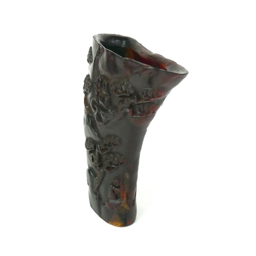 535 - A CHINESE CARVED HORN LIBATION CUP
Red stained with carved decoration of figures in a mountainous la... 