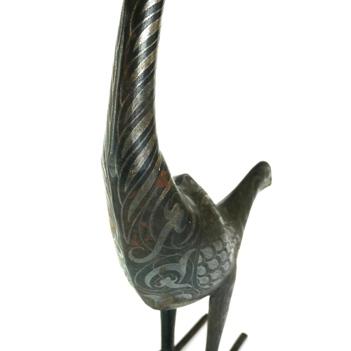 536 - A PERSIAN STYLE METAL MODEL OF A PEACOCK
Inlaid with white metal bands.
(h 61cm)