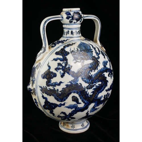 537 - A 20TH CENTURY CHINESE BLUE AND WHITE PORCELAIN MOON FLASK
Both sides decorated with Imperial dragon... 