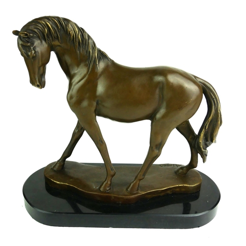 539 - A 20TH CENTURY BRONZE MODEL OF A STANDING HORSE
Raised on an oval black marble base.
(h 30cm)