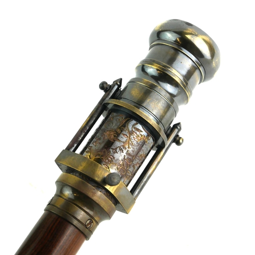 547 - A BRASS AND OAK WALKING CANE WITH TELESCOPE AND COMPASS
The handle set with a glass compass, opening... 