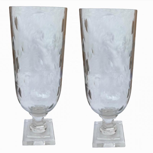 555 - A PAIR OF CUT GLASS STORM LANTERNS
With circular bodies, on stepped plinth bases.
(31cm)

Condition:... 