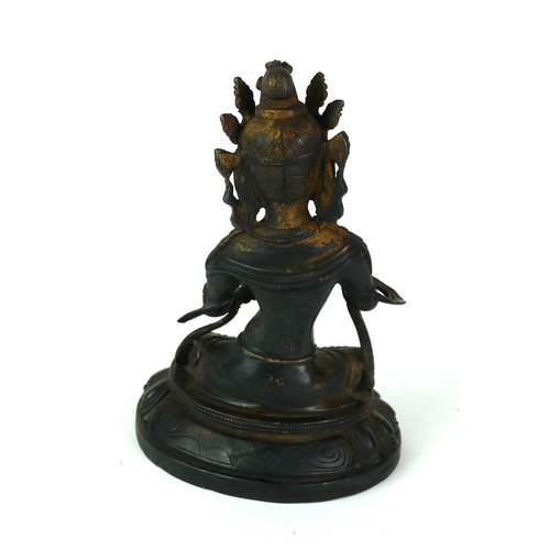 557 - A CHINESE BRONZE FEMALE BUDDHA FIGURE
Seated pose wearing an elaborate headdress and six character i... 