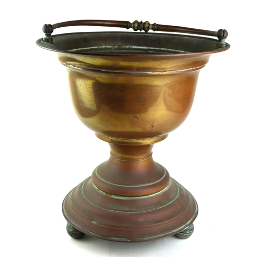 562 - A LATE 19TH CENTURY COPPER PLANTER OF TROPHY FORM 
With swing handle, on bun feet.
(diameter 35cm x ... 