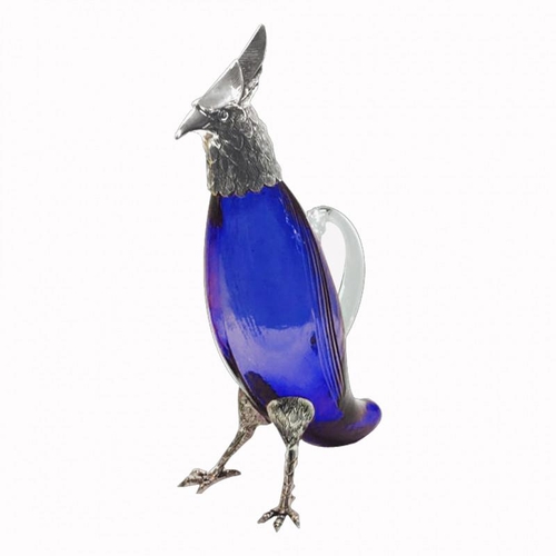 566 - A BRISTOL BLUE GLASS A SILVER PLATE CARAFE FORMED AS A PARROT
With amber glass eyes.
(29cm)

Conditi... 