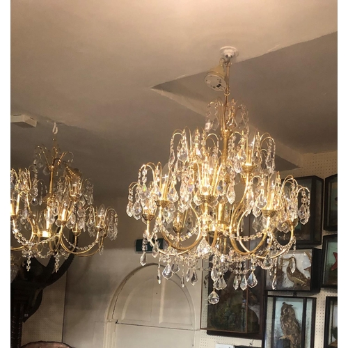 569 - A SET OF THREE GILT METAL AND CRYSTAL EIGHT BRANCH CHANDELIERS. 
(75cm)

Condition: some prisms miss... 