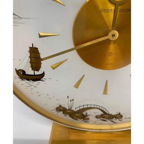 576 - JAEGER-LECOULTRE, A MID CENTURY CLOCK
With gilt metal chinoiserie decoration. 
(h 20cm x diameter 19... 