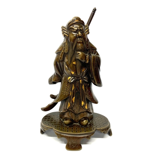 577 - A JAPANESE MEIJI PERIOD BRONZE MODEL OF A WARRIOR 
With gilt and silver decoration, on a shaped base... 