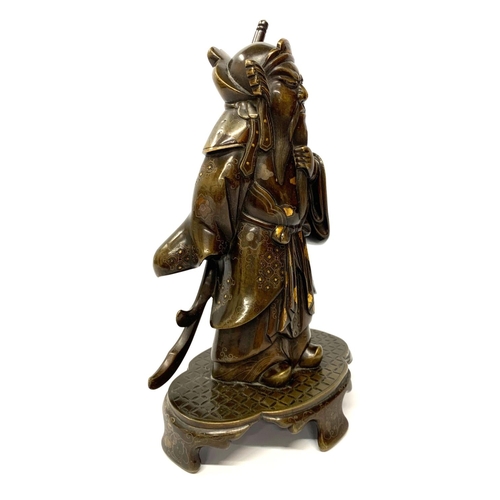 577 - A JAPANESE MEIJI PERIOD BRONZE MODEL OF A WARRIOR 
With gilt and silver decoration, on a shaped base... 