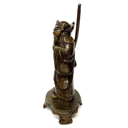 577 - A JAPANESE MEIJI PERIOD BRONZE MODEL OF A WARRIOR 
With gilt and silver decoration, on a shaped base... 