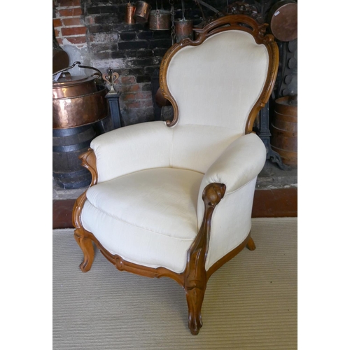 703 - A 19TH CENTURY FRENCH ARMCHAIR
Upholstered in a cream water silk, the mahogany frame with carved and... 