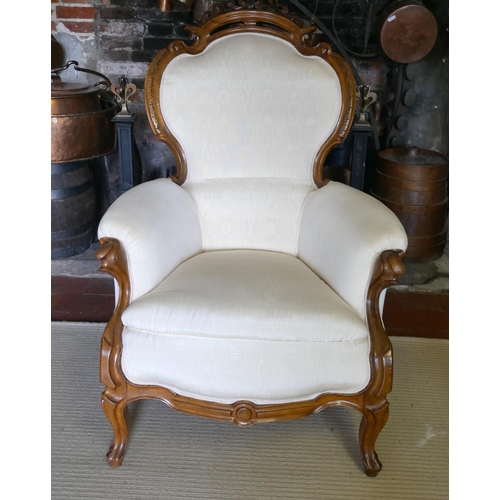 703 - A 19TH CENTURY FRENCH ARMCHAIR
Upholstered in a cream water silk, the mahogany frame with carved and... 