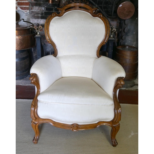 703 - A 19TH CENTURY FRENCH ARMCHAIR
Upholstered in a cream water silk, the mahogany frame with carved and... 