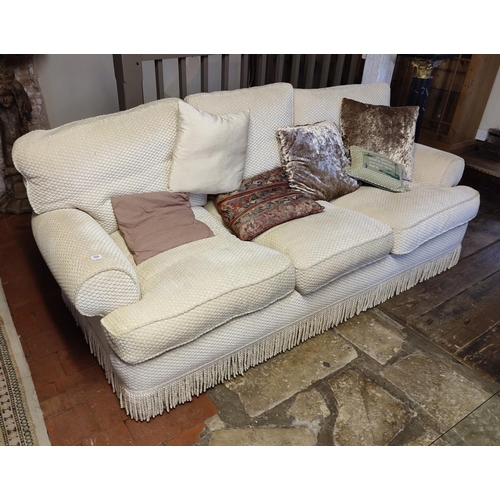 705 - A PAIR OF GOOD QUALITY THREE SEATER SOFAS
Upholstered in a cut cream fabric, complete with loose cus... 