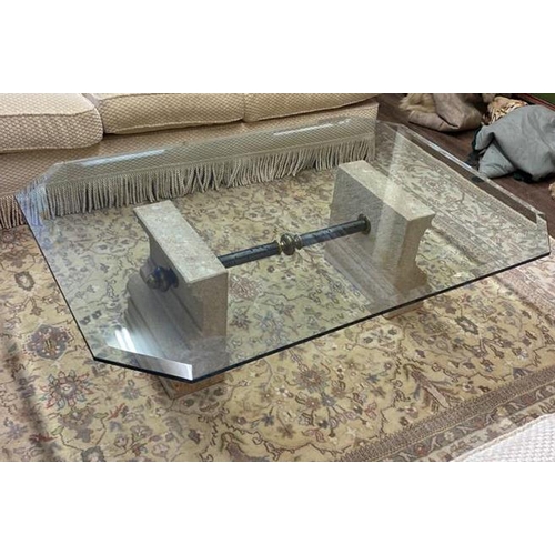 706 - A 20TH CENTURY COFFEE TABLE
With clear bevelled glass top supported on carved stone plinths, joined ... 