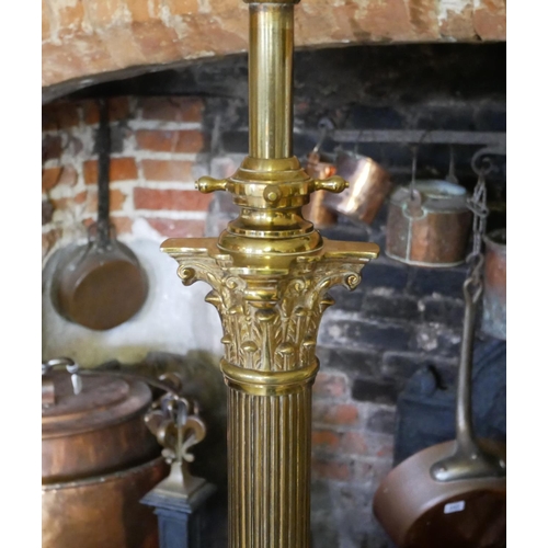 708 - A BRASS ADJUSTABLE STANDARD LAMP
With Corinthian capital on a fluted column and platform base termin... 