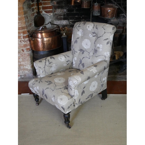 711 - A 19TH CENTURY EASY ARMCHAIR
In oatmeal floral fabric upholstery, raised on turned and fluted legs o... 